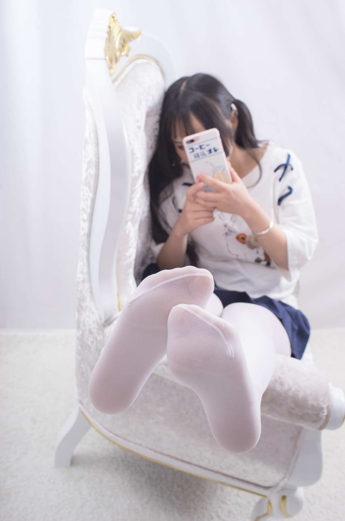白色长筒袜与手机